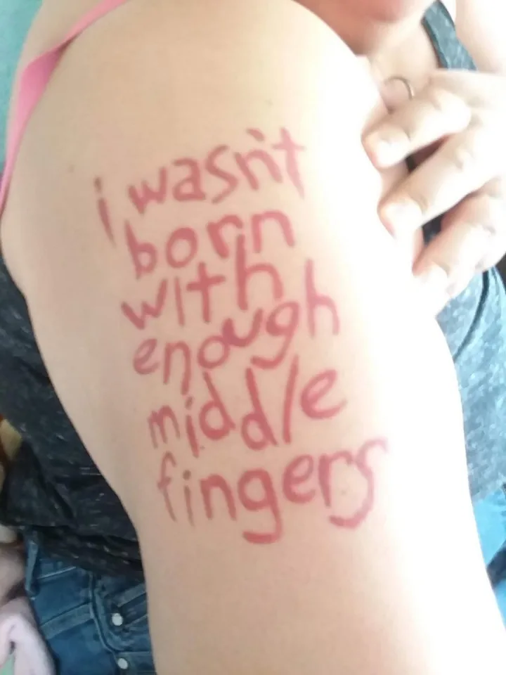 unul sau mai multi oameni, henna si text care spune washit born enough with. middle fingers